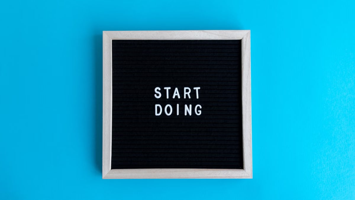 Black letter board with 'START DOING' text on a vibrant blue background.